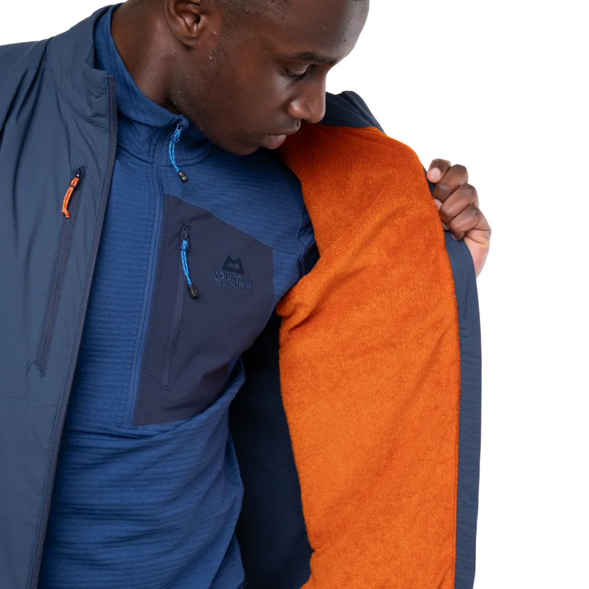 Mountain Equipment Switch Men's Vest in Dusk/Cosmos packed into hand pocket showing lightweight packable construction with twin carabiner carry loops