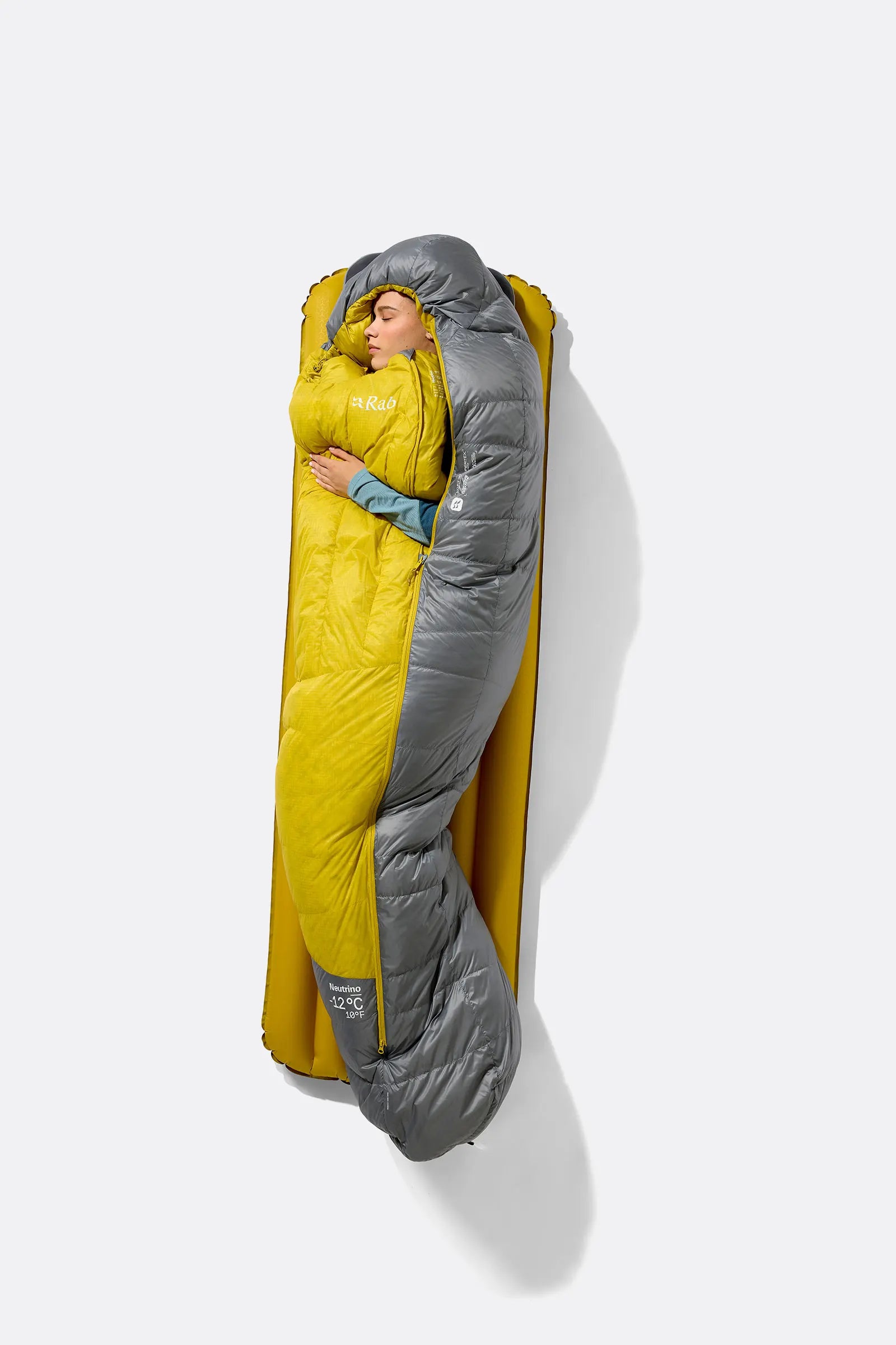 Rab Women's Neutrino Down Sleeping Bag in Zinc/Dark Pollen - worn seated