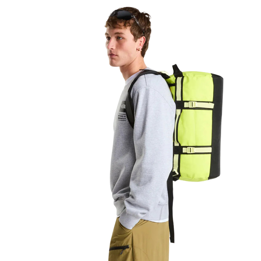 The North Face Base Camp Duffel Extra Small Fizz Lime/Lemon Mist/TNF Black - side view with detachable ergonomic shoulder straps and padded handles