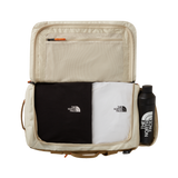 The North Face Base Camp Voyager Duffel 42L Desert Stone/Cedar/Desert Rust - side view with detachable padded shoulder straps and grab handles