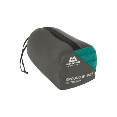 Mountain Equipment Groundup Rectangular Sleeping Bag Liner in Spruce Stripe in stuff sack showing lightweight packable construction